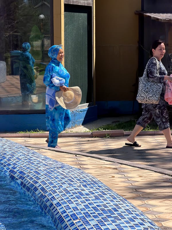 Sunny poolside hangout with swimming, wading, and poolside strolls