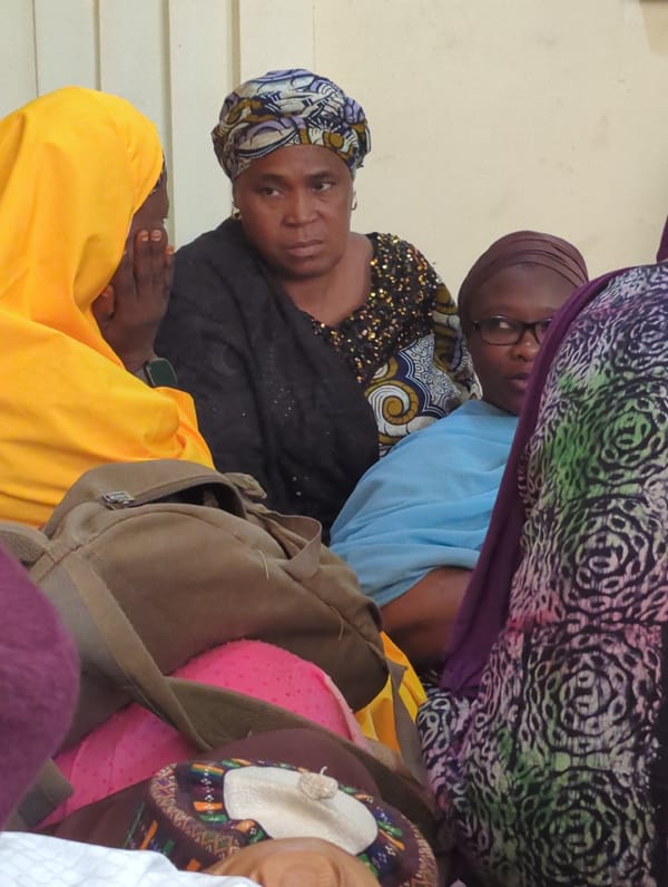 Indoor gathering observed with women in traditional dress