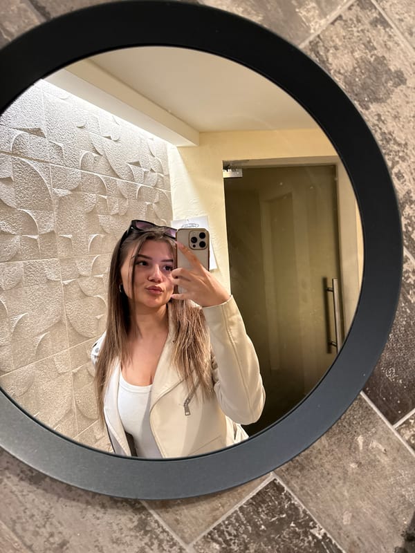 Woman takes selfie in round mirror in Sofia
