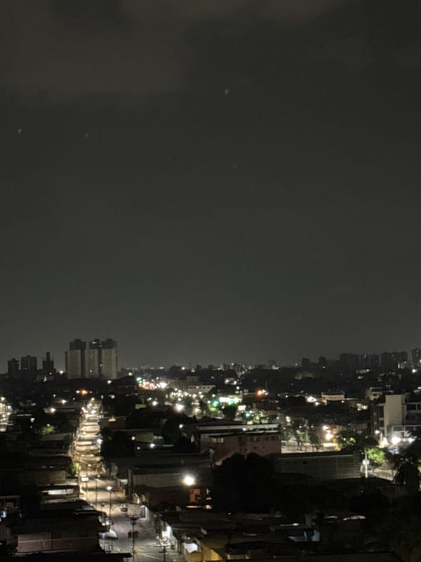 Nighttime cityscape captured in Maracay, Venezuela under overcast skies