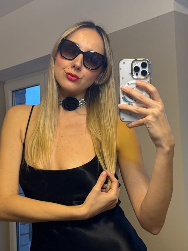 Woman takes wine selfies in room with fish tank