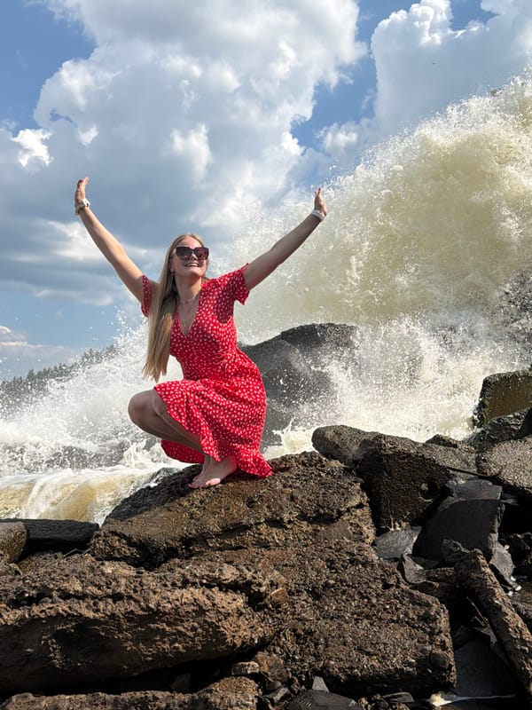 Visitors pose at industrial waterfall in Chernushka, Russia