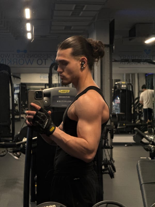 Young man takes mirror selfies at Sofia gym