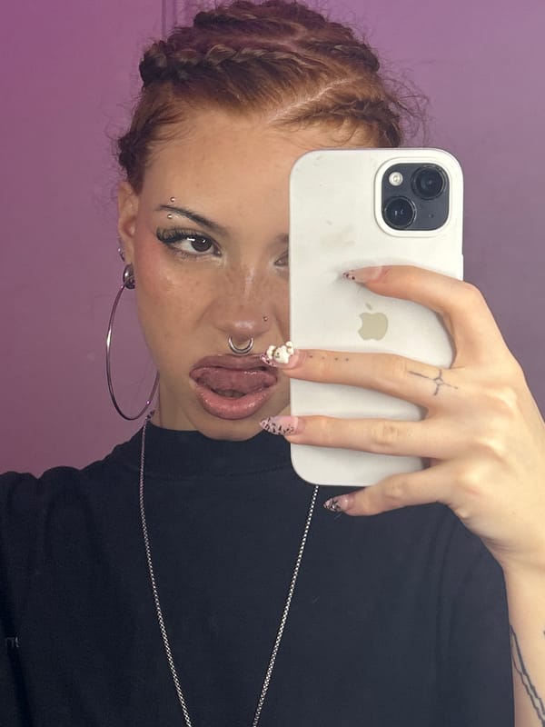 Woman takes selfies as street band performs in Buenos Aires