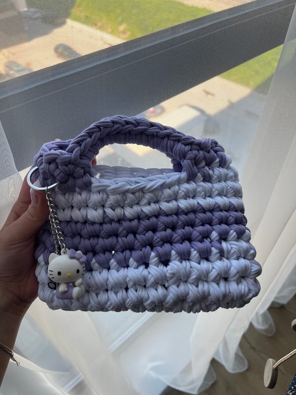 Handmade crocheted purse with Hello Kitty charm displayed in Plovdiv
