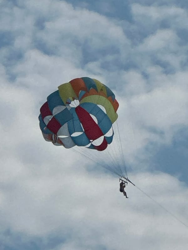 Parasailing above Budva's coastline on a summer afternoon