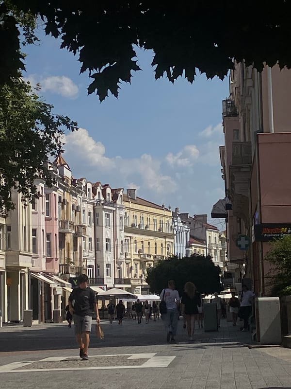 Strolling a colorful European streetscape lined with trees