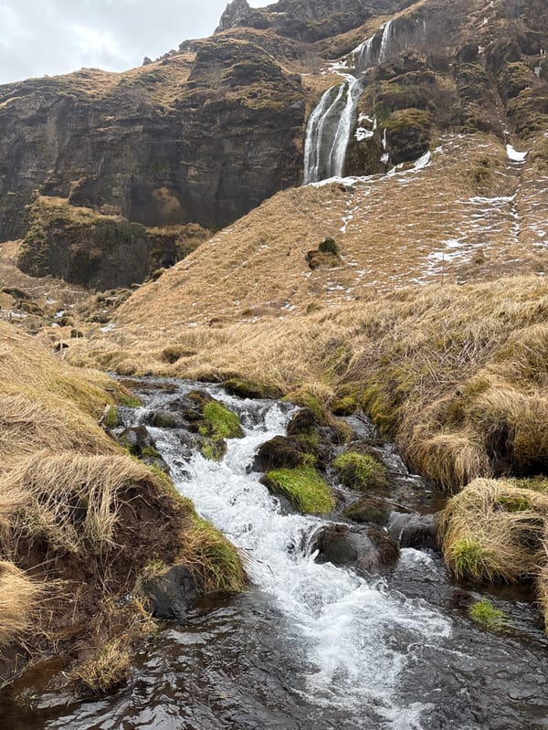 Winter waterfall landscapes documented in Iceland under grey skies