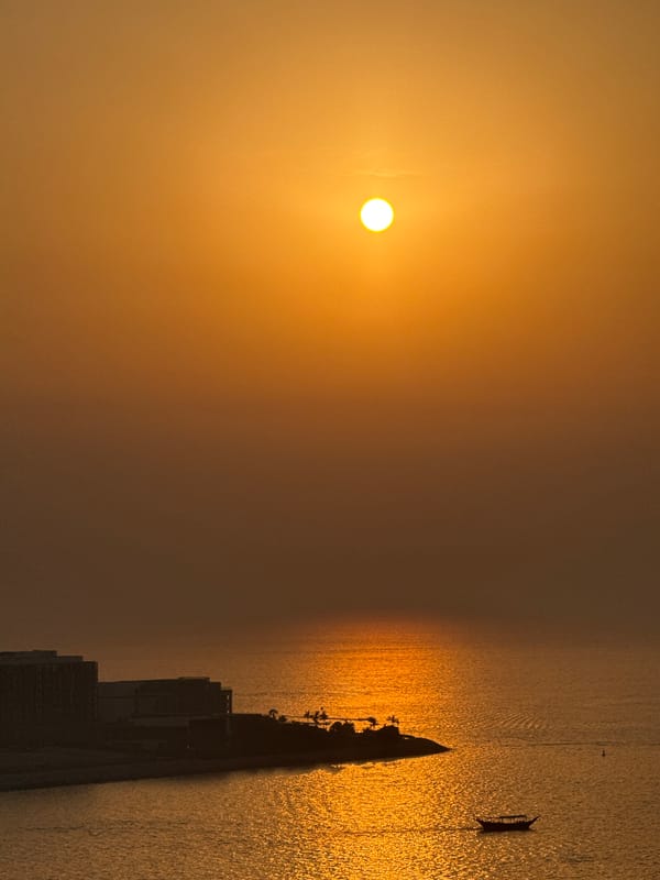 Golden sunset over the Arabian Gulf with Ain Dubai in view