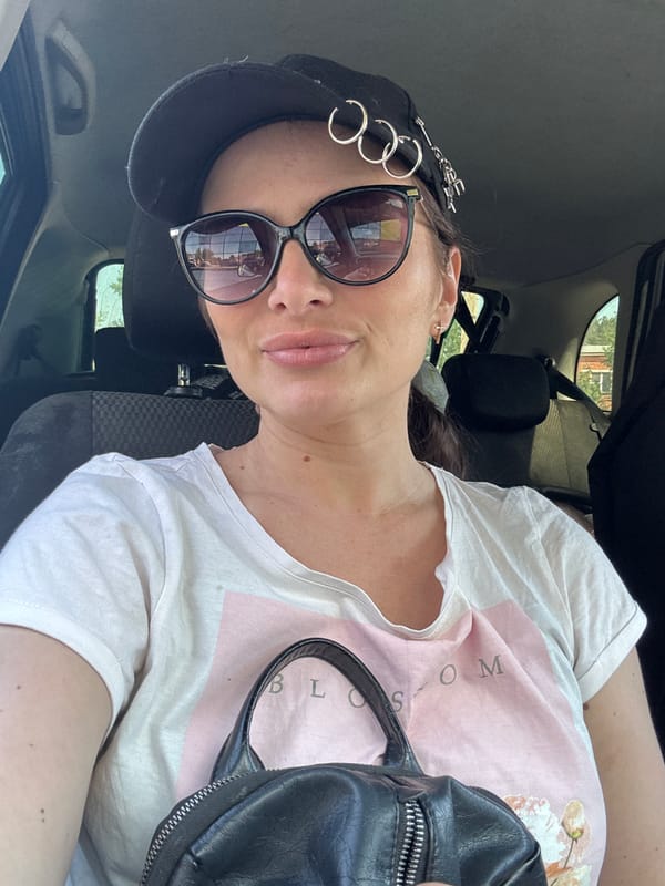 Woman in sunglasses photographed in car in Chaikovsky, Russia