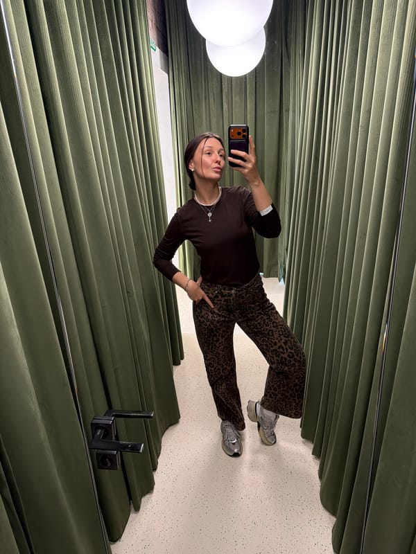 Woman takes mirror selfie in Moscow boutique fitting room