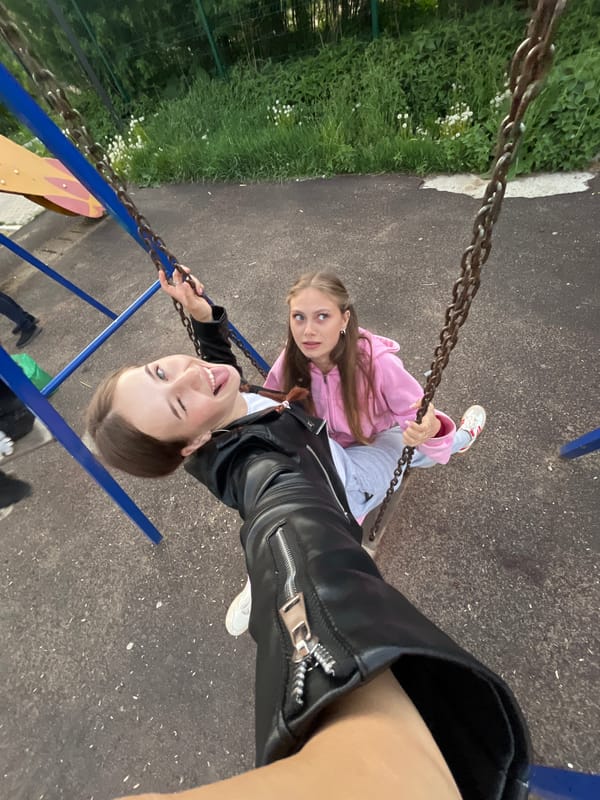 Friends enjoy afternoon playground time in Russian village
