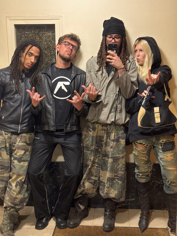 Group poses with rock-on gestures in Paris indoor gathering