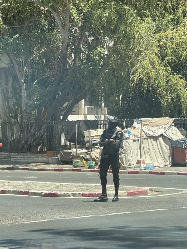 Dakar street scenes captured showing uniformed person, yellow taxi