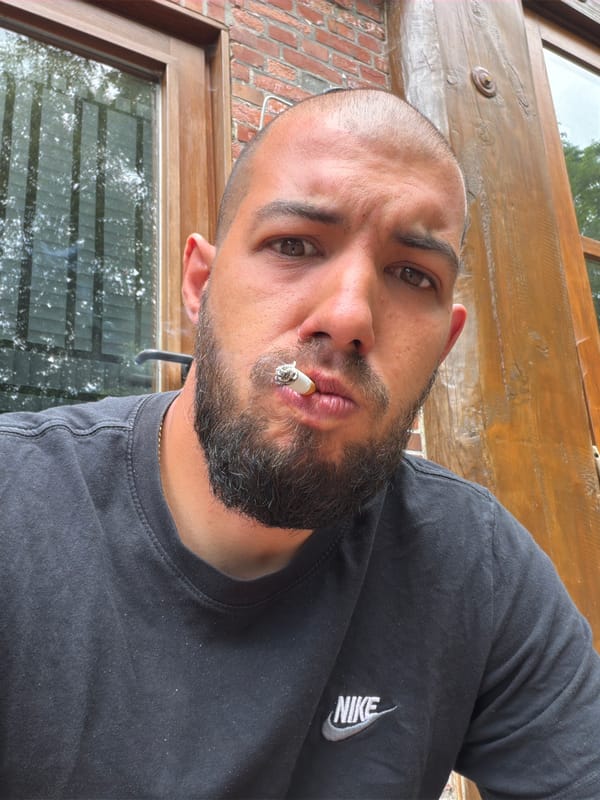 Man smoking outside wooden building in Ovelgönne Saturday morning