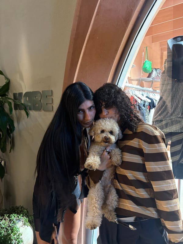 Two people, dog pose outside Wynwood vintage store