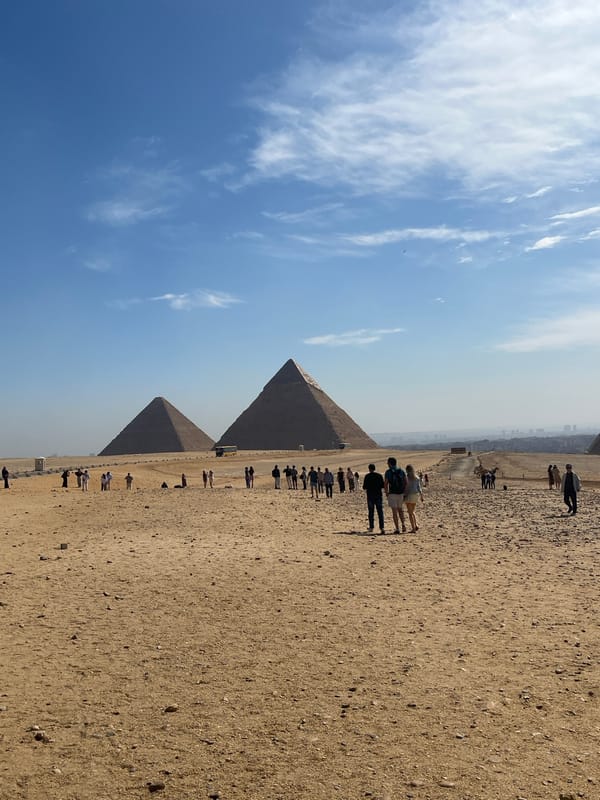 Tourists visit Great Pyramids of Giza under cloudy skies
