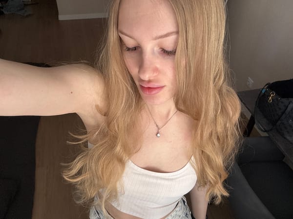 Woman takes selfies in bedroom in Perm, Russia