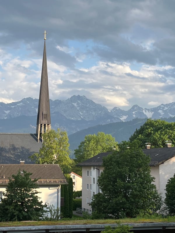 Church steeple and Alpine peaks captured in Garmisch-Partenkirchen