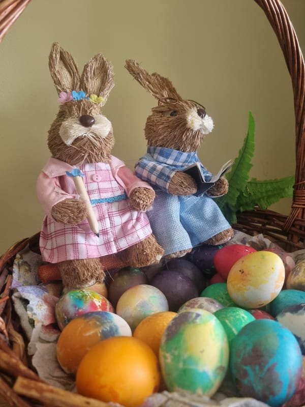Easter basket with colorful eggs and bunny figurines observed