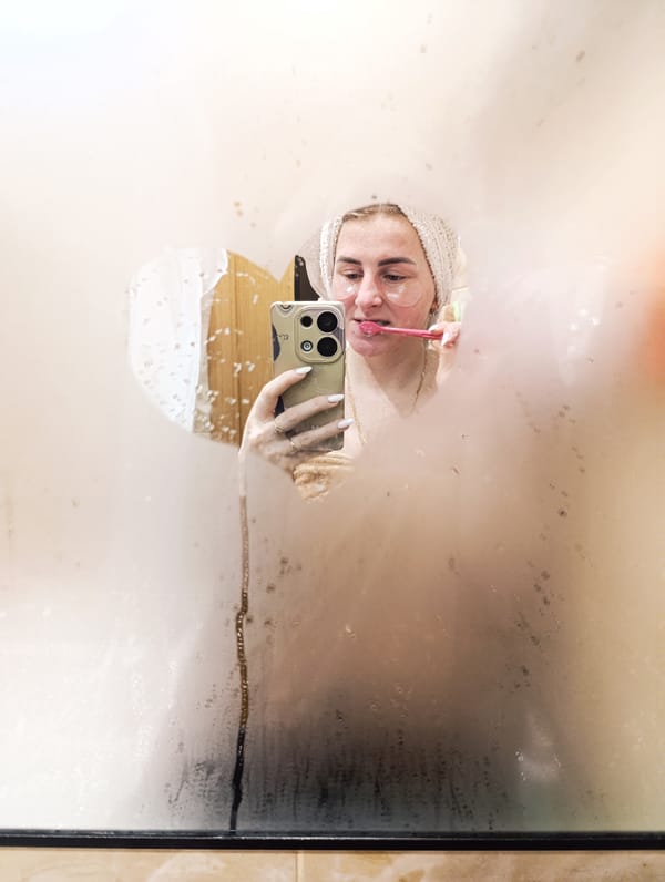 Woman observed during morning bathroom routine with towel, eye patches