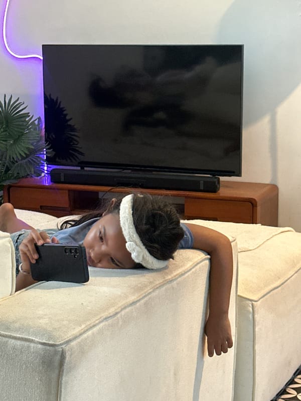 Lounging on a sofa, deep in a phone screen