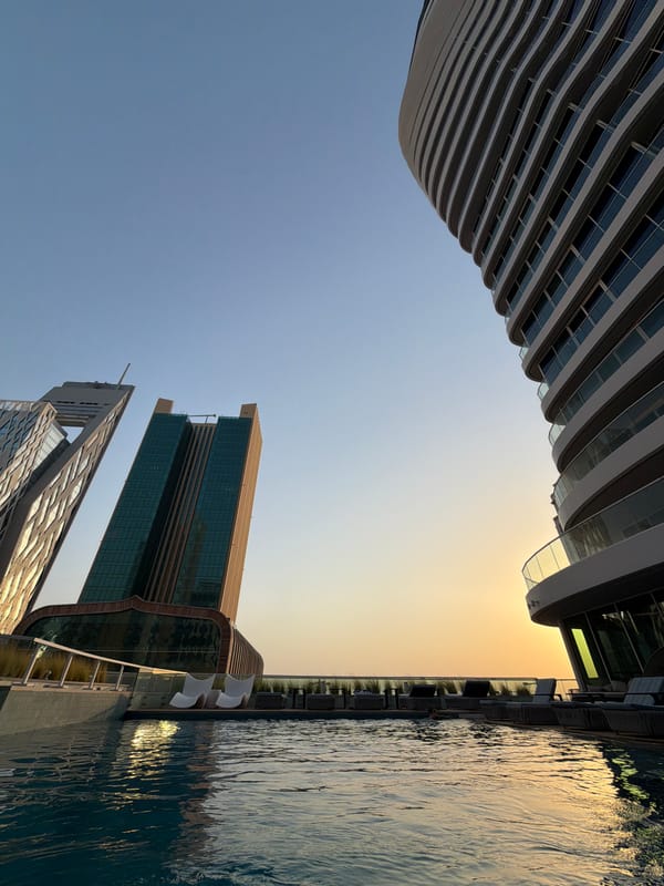 Lusail rooftop pool at sunset, skyline views and city streets