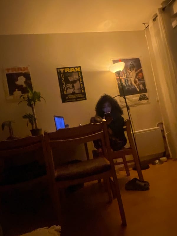 Person sits at desk in dimly lit Aubervilliers room