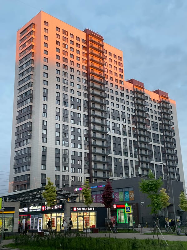 Evening cityscape captured showing modern residential buildings at sunset