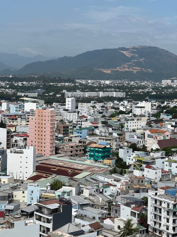 Nha Trang cityscape meets green mountains from above