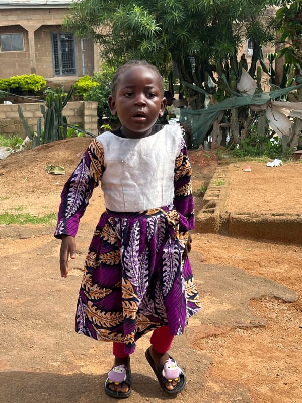 Everyday street scene outside a building in Jos, Nigeria
