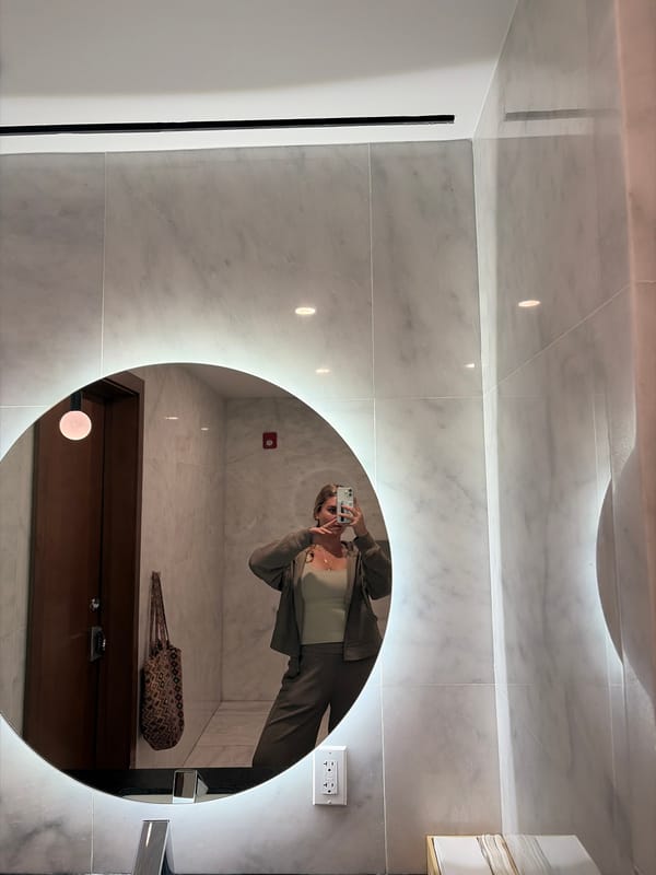 Person Takes Mirror Selfie in Miami Bathroom