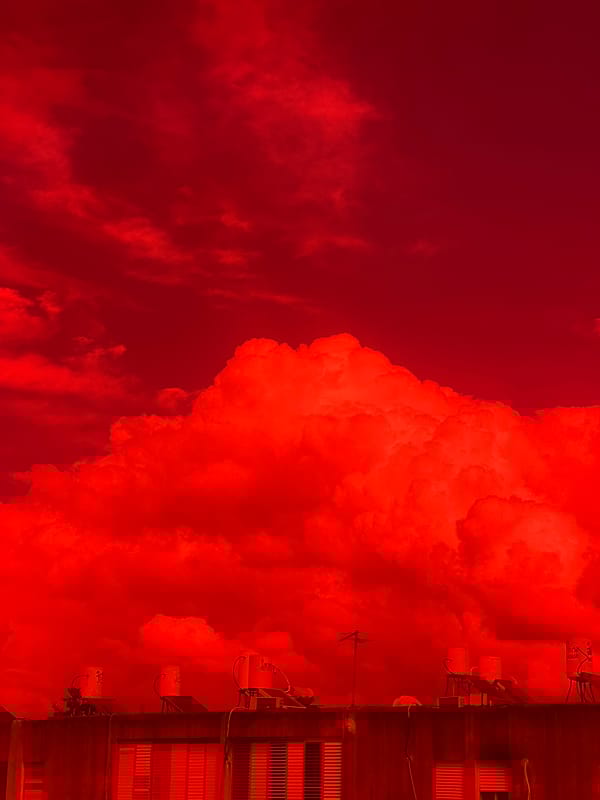 Morning scenes captured in Kiryat Bialik show clouds, trees, flagged building