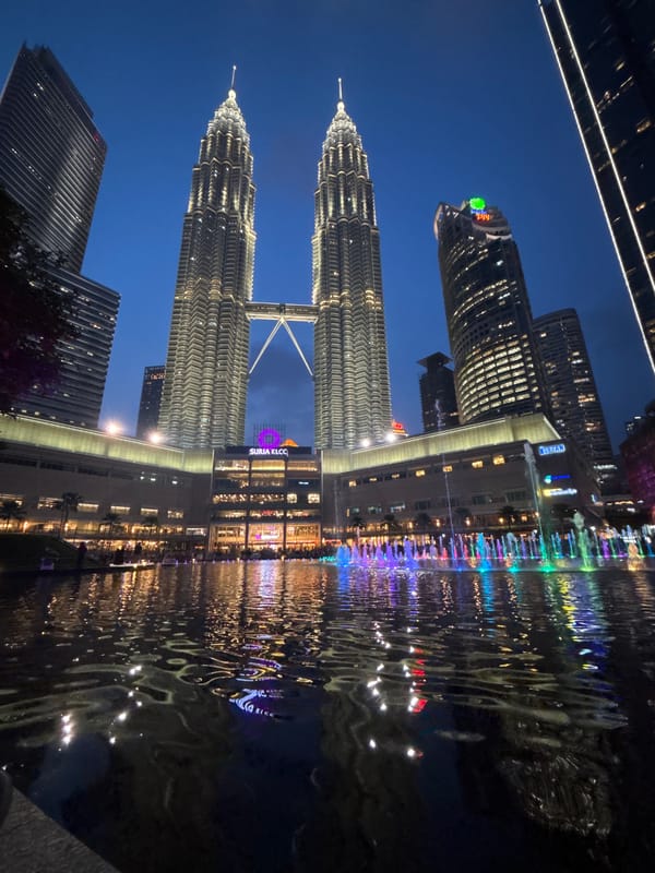 Petronas Twin Towers glowing at dusk in Kuala Lumpur