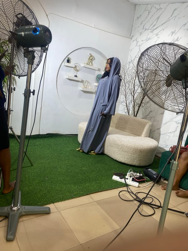 Woman models grey abaya in studio photoshoot in Nyanya