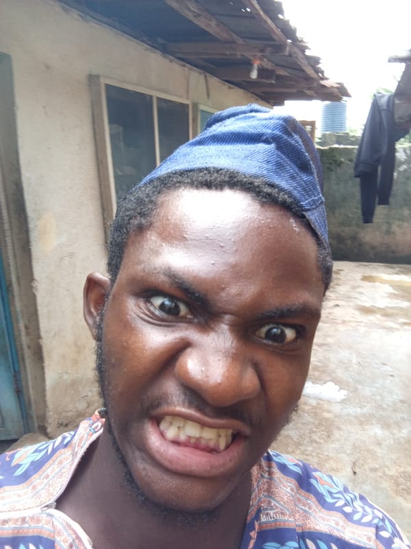 Person in blue cap makes animated faces in selfies