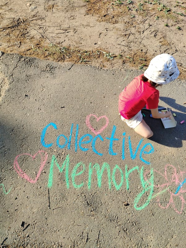 Woman and child create chalk art in Noviy, Russia