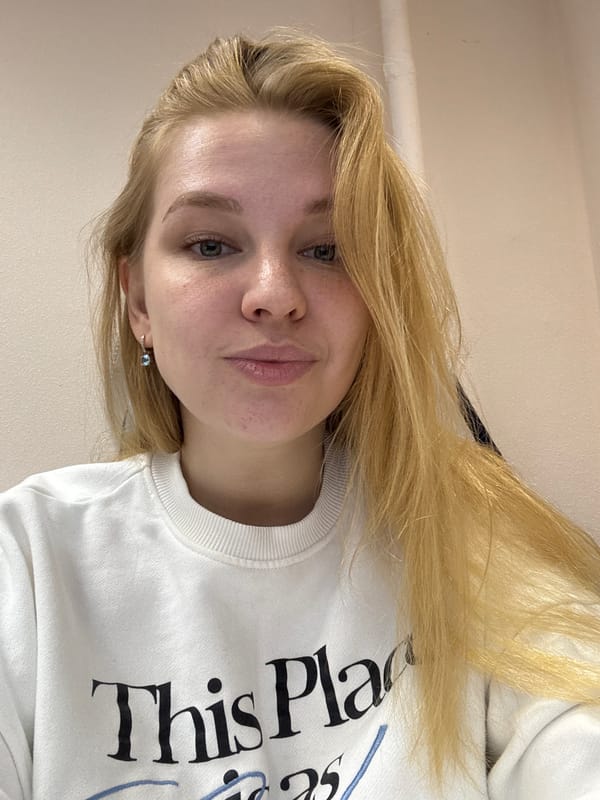 Woman takes selfies in white sweatshirt in Rusanovo