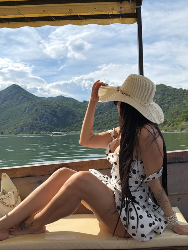Woman in polka dot dress enjoys boat trip in Montenegro