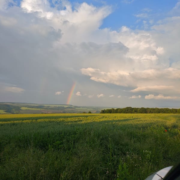 Rainbow appears over rural Bulgarian farmland near Kozitsa
