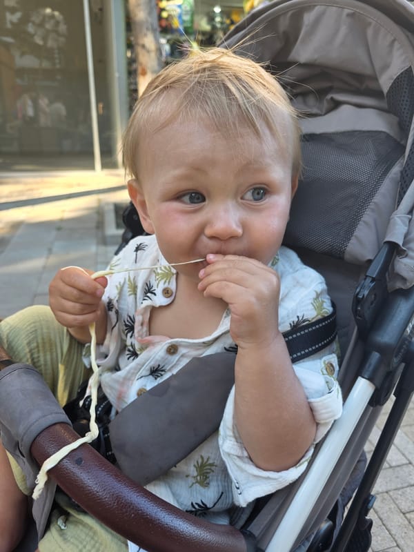 Toddler snack time captured during stroll through Russian tourist district