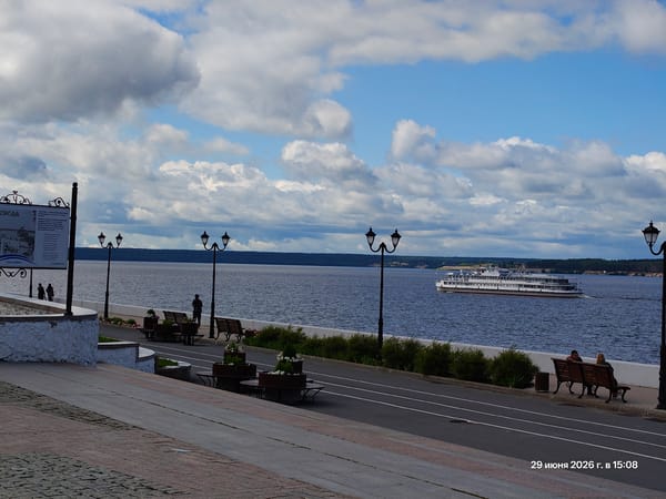 Strolling a riverside promenade on a cloudy urban afternoon