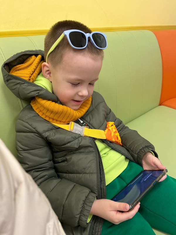 Child rests on colorful cushion in Usman, Russia