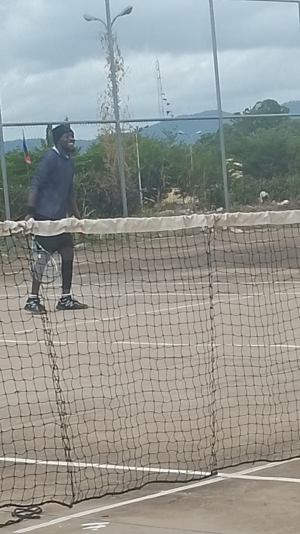 Tennis players active on outdoor courts in Lokoja, Nigeria