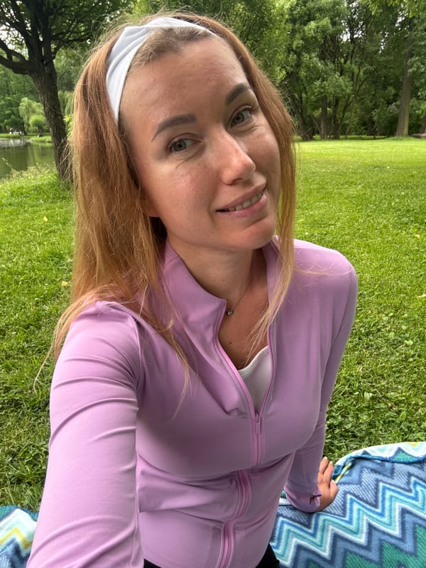 Woman spends afternoon picnicking and relaxing in lakeside park