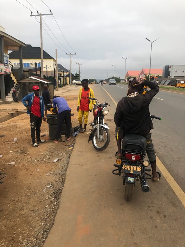 Morning street gathering observed in Abuja with motorcycles, tricycle