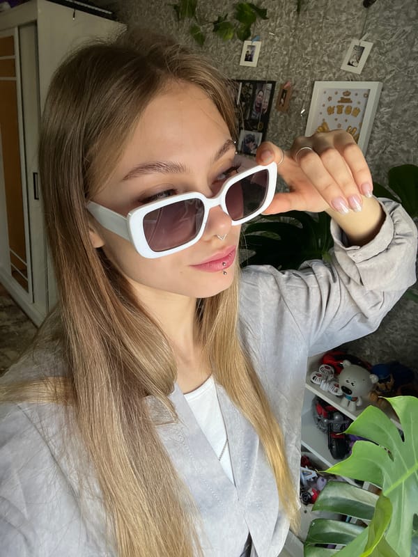 Woman with piercings rests with sunglasses in Foki, Russia