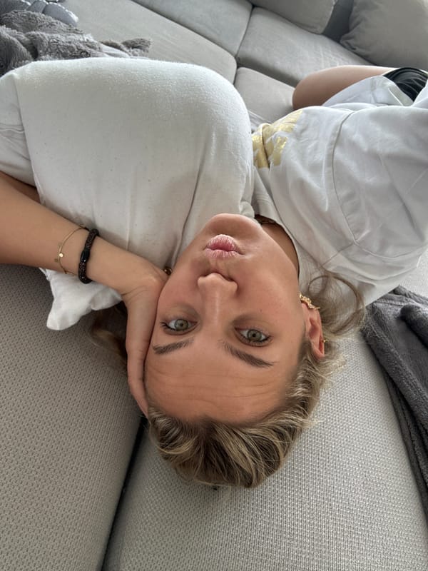 Woman takes playful selfies on couch in French home