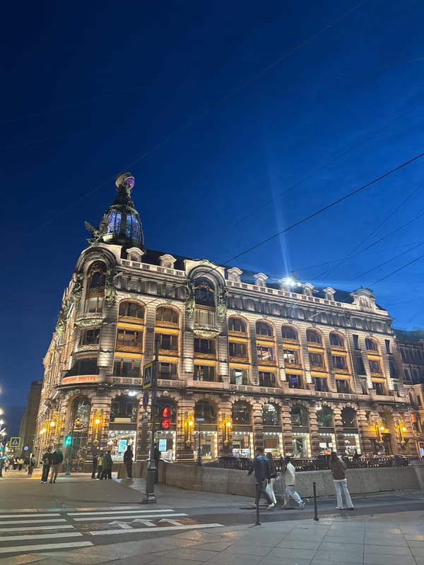 Evening street life unfolds across historic Saint Petersburg landmarks
