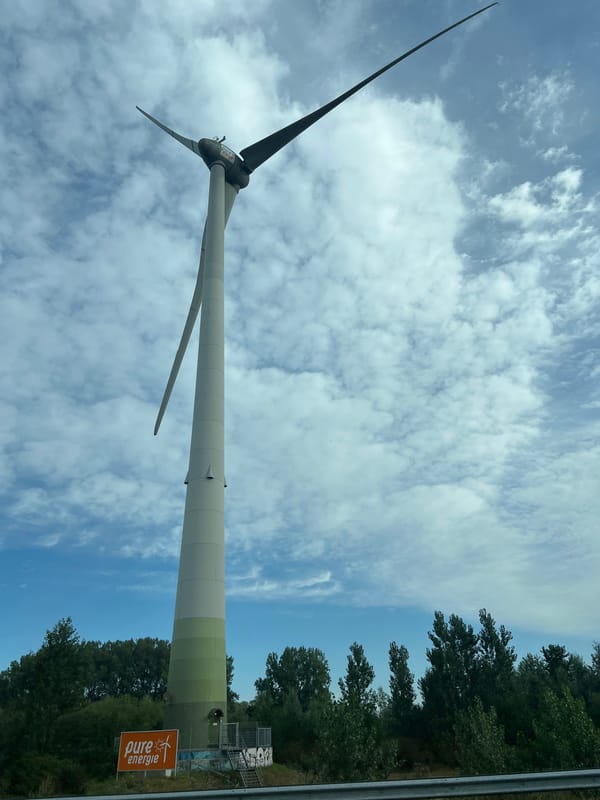 Highway drive through wind turbine country on a cloudy day